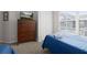 Bedroom featuring twin beds with blue covers, dark wood dresser, and window at 2604 Lodi Cir # 103, Kissimmee, FL 34746