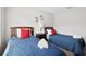 Bright bedroom featuring two beds with red pillows and nautical Mickey Mouse decor at 2604 Lodi Cir # 103, Kissimmee, FL 34746