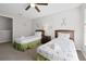 Bright bedroom featuring two beds, a ceiling fan, bedside tables and nautical decor at 2604 Lodi Cir # 103, Kissimmee, FL 34746