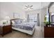 Cozy bedroom with a ceiling fan, large window and a mounted television on a dresser at 2604 Lodi Cir # 103, Kissimmee, FL 34746