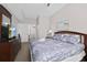 Bedroom showcases a comfortable bed, television on dresser, and access to a bathroom at 2604 Lodi Cir # 103, Kissimmee, FL 34746