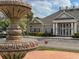 Beautiful clubhouse with a large fountain, manicured landscaping, and ample parking at 2604 Lodi Cir # 103, Kissimmee, FL 34746