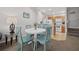 Charming dining area featuring a white table with four chairs, adjacent to the kitchen and living room at 2604 Lodi Cir # 103, Kissimmee, FL 34746