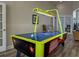Air hockey table in the community game room, featuring overhead lighting and seating nearby at 2604 Lodi Cir # 103, Kissimmee, FL 34746