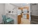 Functional kitchen with wooden cabinets, white appliances, and bar seating, adjacent to stairs at 2604 Lodi Cir # 103, Kissimmee, FL 34746