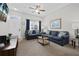 Inviting living room showcasing modern decor, plush blue sofas, and a mounted television for entertainment at 2604 Lodi Cir # 103, Kissimmee, FL 34746