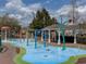 Community splash pad with colorful play features and a shaded gazebo at 2604 Lodi Cir # 103, Kissimmee, FL 34746
