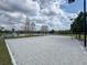 Outdoor sand volleyball court featuring net, seating, and view of nearby lake at 2604 Lodi Cir # 103, Kissimmee, FL 34746