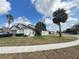 Charming single-story home with palm trees and a well-manicured lawn under a bright blue sky at 2678 Autumn Creek Cir, Kissimmee, FL 34747