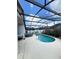 Inviting screened-in pool with surrounding patio and lounge seating, perfect for outdoor relaxation and entertaining at 2678 Autumn Creek Cir, Kissimmee, FL 34747