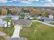 Aerial view of the single-story home in a residential neighborhood with a lake nearby at 2776 Tropical Lake Dr, Kissimmee, FL 34741