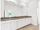 Bathroom vanity featuring double sinks and a granite countertop at 2776 Tropical Lake Dr, Kissimmee, FL 34741