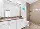 Elegant bathroom with double sinks, granite countertop, large mirror and glass-enclosed shower at 2776 Tropical Lake Dr, Kissimmee, FL 34741