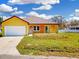 Charming single-story home featuring a front yard, driveway, and attached garage at 2776 Tropical Lake Dr, Kissimmee, FL 34741