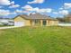 Cheerful yellow home featuring an attached one-car garage and a concrete driveway at 2776 Tropical Lake Dr, Kissimmee, FL 34741
