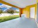 A covered patio featuring a bright yellow paint, concrete floor and a sink at 2776 Tropical Lake Dr, Kissimmee, FL 34741