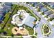 A community pool with playgrounds, surrounded by homes and green landscaping at 2909 Theme St, Kissimmee, FL 34746