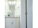 Bright bathroom with modern vanity, lighting, and decorative floral arrangement at 2909 Theme St, Kissimmee, FL 34746