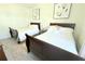 Bedroom showcasing two beds with matching dark wood frames and neutral walls at 2909 Theme St, Kissimmee, FL 34746