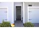Home entryway with a gray front door and a well-lit walkway at 2909 Theme St, Kissimmee, FL 34746