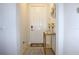 Bright foyer with a white front door, a decorative table, and tile flooring at 2909 Theme St, Kissimmee, FL 34746