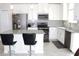 Modern kitchen featuring white cabinets, stainless steel appliances, and a kitchen island with seating at 2909 Theme St, Kissimmee, FL 34746