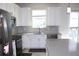 Stylish kitchen offers stainless appliances, gray subway tile backsplash, white cabinetry, and light countertops at 2909 Theme St, Kissimmee, FL 34746