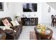 Comfortable living room with a leather sofa, a decorative coffee table, and a TV console at 2909 Theme St, Kissimmee, FL 34746
