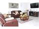 Cozy living room with a large leather sofa and stylish decor accents at 2909 Theme St, Kissimmee, FL 34746