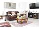 Spacious living room with leather seating, a coffee table, and modern entertainment center at 2909 Theme St, Kissimmee, FL 34746