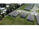 Aerial view of gray home exteriors, lush lawns, and community street at 30376 Armenia Rd, Leesburg, FL 34748