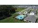 Aerial view of a community showcasing a pool, community center, and homes at 30376 Armenia Rd, Leesburg, FL 34748