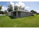 View of back of home with backyard and covered patio at 30376 Armenia Rd, Leesburg, FL 34748
