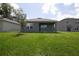 View of back of home featuring backyard and small covered patio at 30376 Armenia Rd, Leesburg, FL 34748