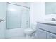 A bathroom featuring a shower-tub combination and single sink vanity with gray cabinets at 30376 Armenia Rd, Leesburg, FL 34748