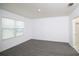 Bedroom featuring neutral walls and flooring, with a bright window and an attached bathroom at 30376 Armenia Rd, Leesburg, FL 34748