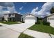 Single-story home featuring an attached two car garage, driveway and front lawn at 30376 Armenia Rd, Leesburg, FL 34748