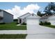 Inviting single-story home with a two-car garage, well-manicured lawn, and neutral exterior paint scheme at 30376 Armenia Rd, Leesburg, FL 34748
