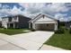 Single story home with an open two car garage and manicured lawn at 30376 Armenia Rd, Leesburg, FL 34748