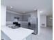 A kitchen featuring gray cabinets, stainless steel appliances, and light countertops, offering a modern and functional space at 30376 Armenia Rd, Leesburg, FL 34748