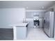 Modern kitchen featuring stainless steel appliances, light gray cabinets, and bright countertops at 30376 Armenia Rd, Leesburg, FL 34748