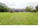 Expansive backyard with a covered porch, full fencing, and mature trees provide privacy and plenty of space at 3725 Blossom St, Kissimmee, FL 34746
