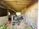 Open barn featuring a tractor, boat, and miscellaneous farm equipment at 3725 Blossom St, Kissimmee, FL 34746