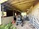 Open barn featuring a tractor, boat, and miscellaneous farm equipment at 3725 Blossom St, Kissimmee, FL 34746