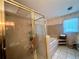 Bathroom with a glass shower and tub at 3725 Blossom St, Kissimmee, FL 34746