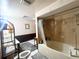 Bathroom with tub/shower combo and neutral color palette, featuring a skylight at 3725 Blossom St, Kissimmee, FL 34746