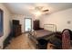 Bedroom featuring a gold-colored bed frame, tile flooring, and a ceiling fan at 3725 Blossom St, Kissimmee, FL 34746