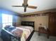 Bedroom featuring a ceiling fan, a bed with a colorful comforter, and a side table at 3725 Blossom St, Kissimmee, FL 34746