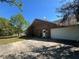 Brick home featuring a two-car garage and backyard access at 3725 Blossom St, Kissimmee, FL 34746
