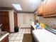 Laundry room features a utility sink, cabinets, washer and dryer hookups and natural light from the skylight at 3725 Blossom St, Kissimmee, FL 34746